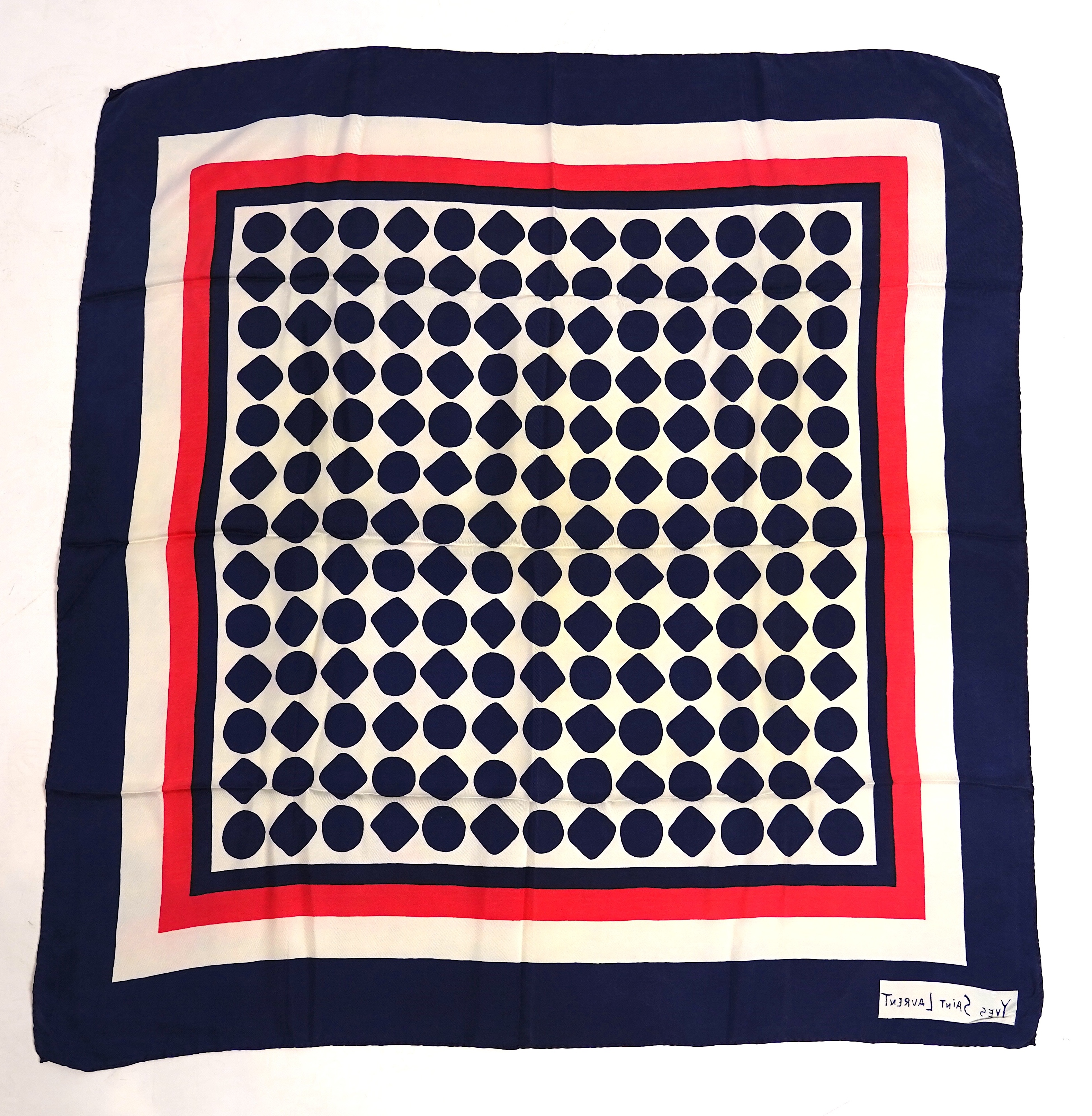 A Yves Saint Laurent silk scarf, a Jean Cocteau zodiac design silk scarf and a Rodier silk scarf.